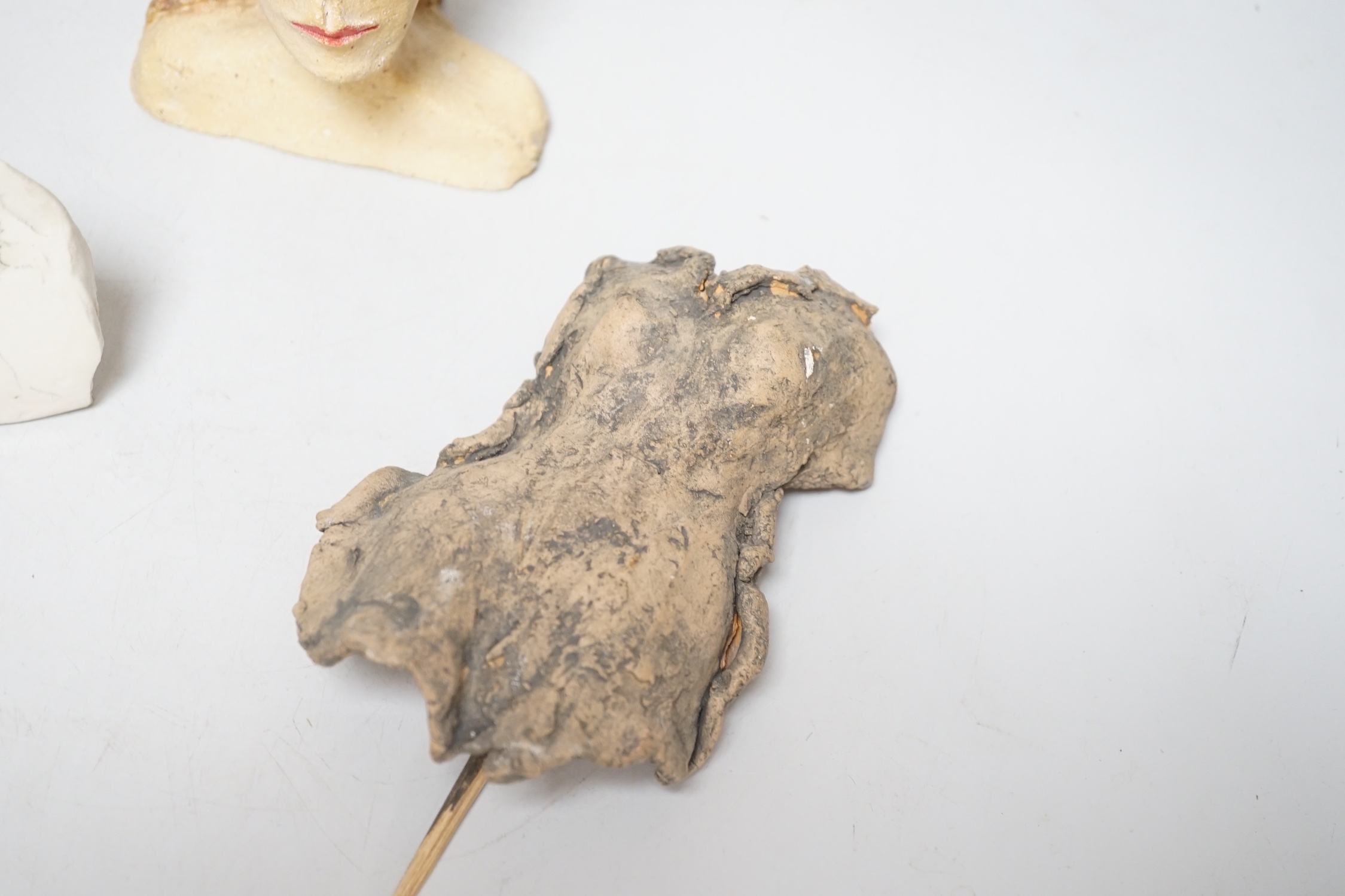 Coral Pearson-Revel (New Zealand) - three works - a painted terracotta head and shoulders of a woman, 12cm, a terracotta woman’s torso, dated 2007 and a half circle plaque, painted with a bust of a woman, each signed
